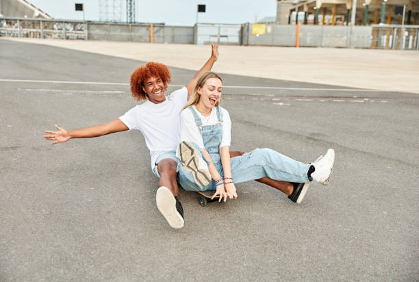 istock Two skateboarders playing together with one skate on a skate park 1672469238