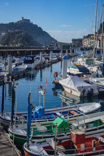 San Sebastian, Spain - April 2, 2021: Boats in the marina in La Concha Bay at the foot of Mt. Urgull