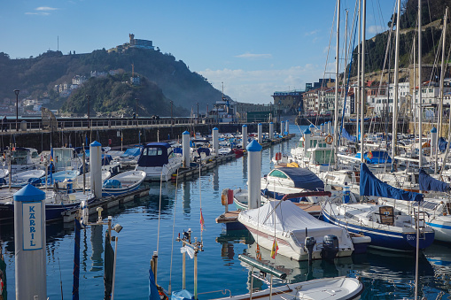 San Sebastian, Spain - April 2, 2021: Boats in the marina in La Concha Bay at the foot of Mt. Urgull