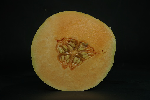 Melon on black background , close up view