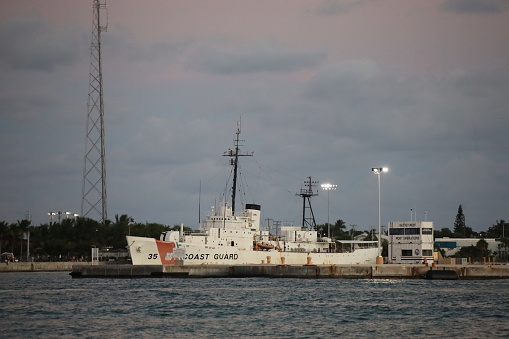 Coast Guard ship at the dock. Cloudy sky, Sunset time. Caribbean region. Anywhere.
