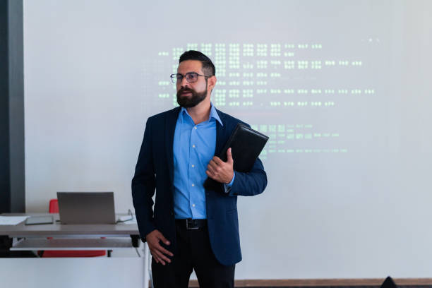 istock Mid adult man doing a presentation at meeting office 1672500177