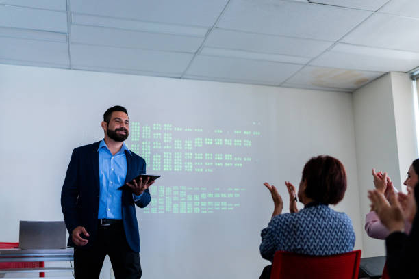 istock Mid adult man doing a presentation at meeting office 1672501262