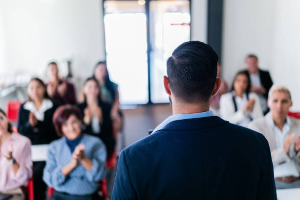 istock Mid adult man doing a presentation at office meeting 1672501785