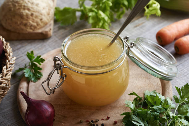 istock Bone broth in a glass jar with fresh vegetables 1672502341