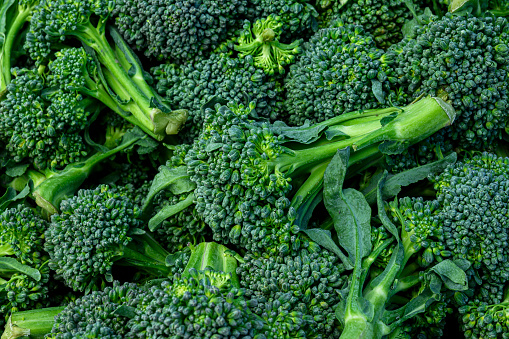 Close-up of organic broccoli at outdoor farmer's market.