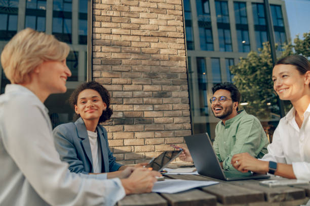 istock Smiling colleagues working together developing business strategy for project on office terrace 1672508889