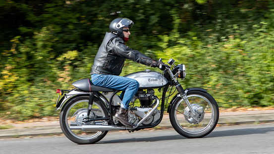 Milton Keynes,UK-Sept 10th 2023: 1970 silver Triton - Triumph Norton - motorcycle travelling on an English road.A Triumph engine in a Norton frame.