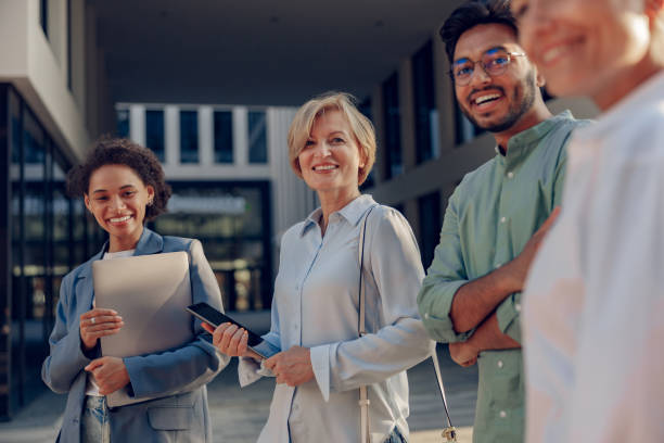 istock Professional business team talks during break standing on background of modern office building 1672511094