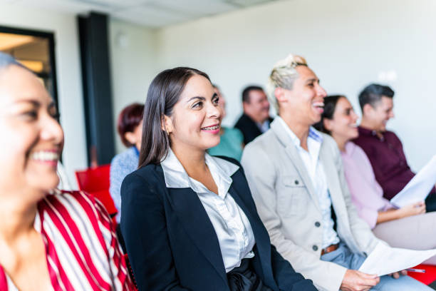 istock Coworkers watching a presentation at office 1672512171