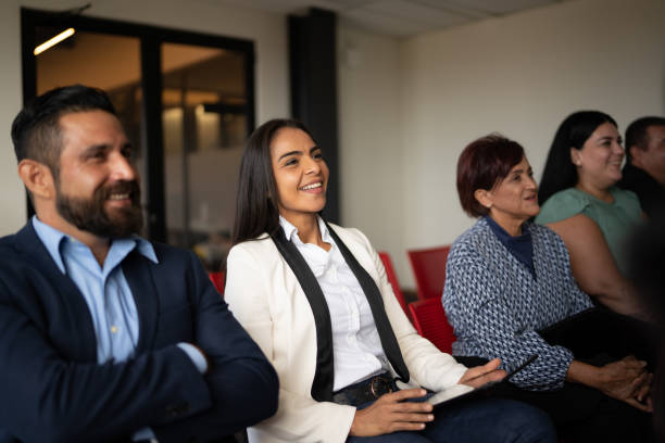 istock Coworkers watching a presentation at office 1672512178