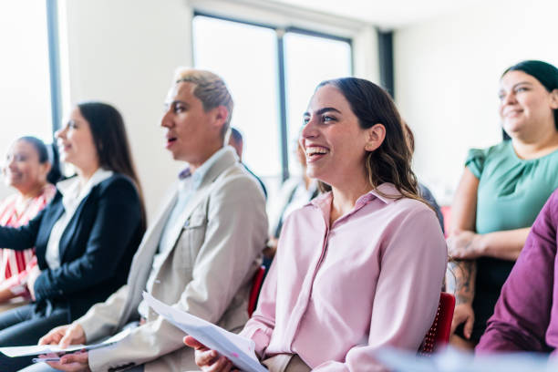 istock Coworkers watching a presentation at office 1672512203