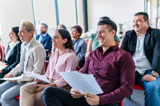 istock Coworkers watching a presentation at office 1672512717