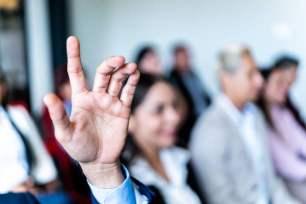istock Businessman with raised hand on a meeting at office 1672513269