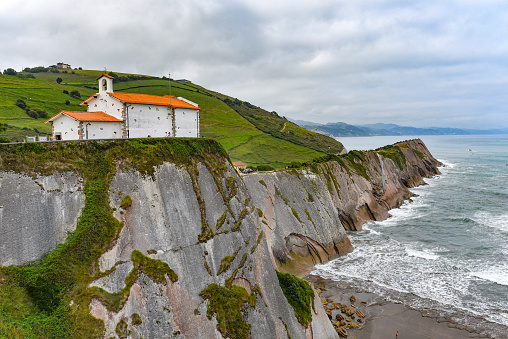 Zumaia, Spain - 14 August 2021: San Telmo Church and the Flysch Cliffs on the coast of Zumaia, Gipuzkoa