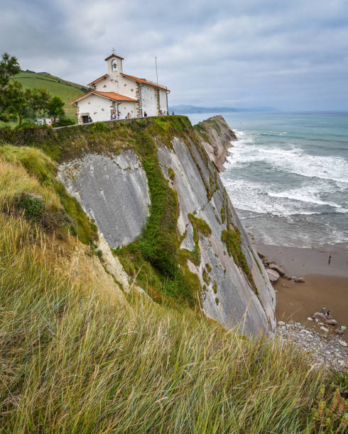 スペイン、スマイアの海岸にあるサンテルモ教会とフリッシュの崖 - vizcay ストックフォトと画像