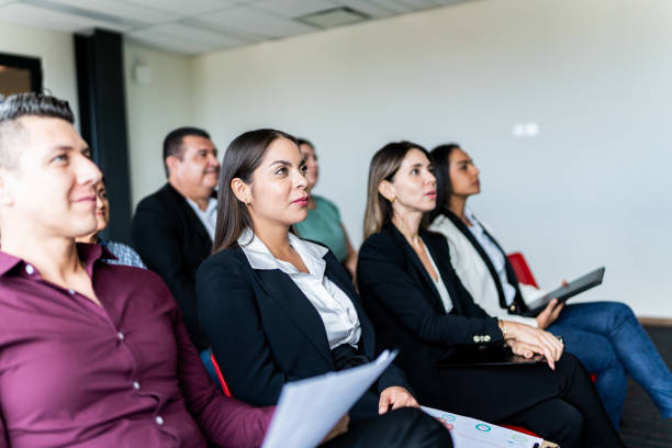istock Coworkers listening a presentation at office 1672515444