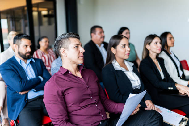 istock Coworkers listening a presentation at office 1672515576