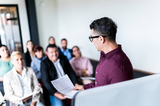 istock Mid adult businessman doing a presentation at office 1672518458
