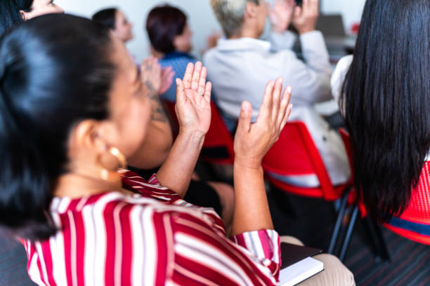 istock Mature woman applauding a presentation at office 1672519288