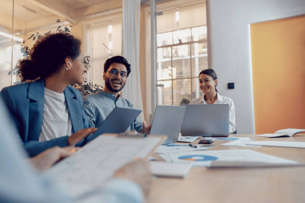 istock Coworkers discussing biz related problem in the office and using laptop. Conception of business team 1672528639