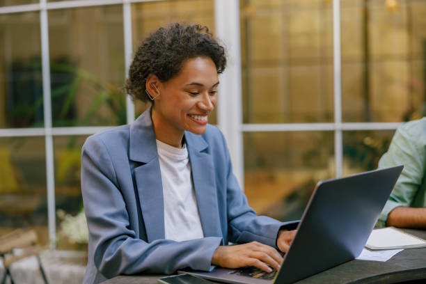 istock Smiling female sales manager working on laptop on modern office terrace 1672533009