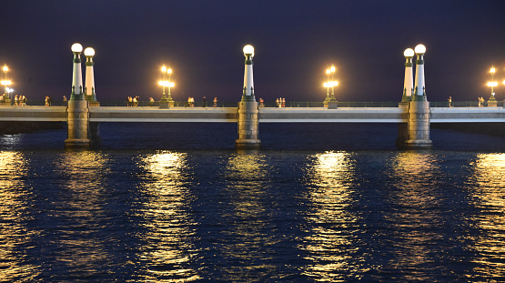 San Sebastian, Spain - 29 Aug 2021: Lights from the Kursal Bridge reflecting on the waters of the Urumea River