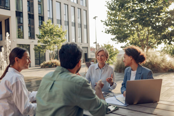 istock Smiling colleagues working together developing business strategy for project on office terrace 1672542247