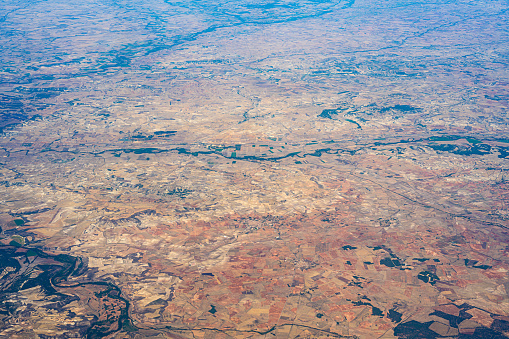 Description: Aerial view of dry agricultural fields and wind farms with many wind turbines. North Spain, Europe.