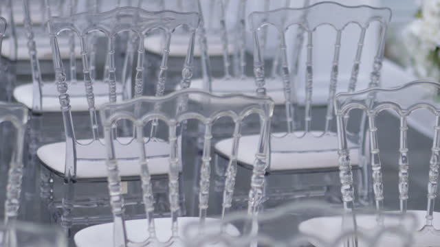 White transparent plastic Chiavari chairs in rows, Wedding ceremony