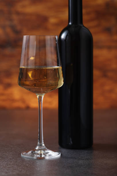 istock Excellent white wine on a wooden background 1672568082