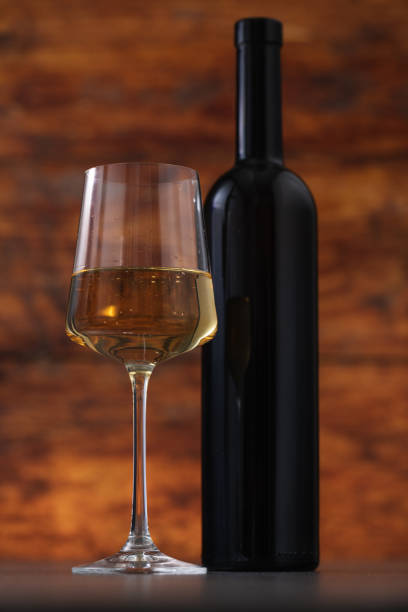 istock Excellent white wine on a wooden background 1672568085