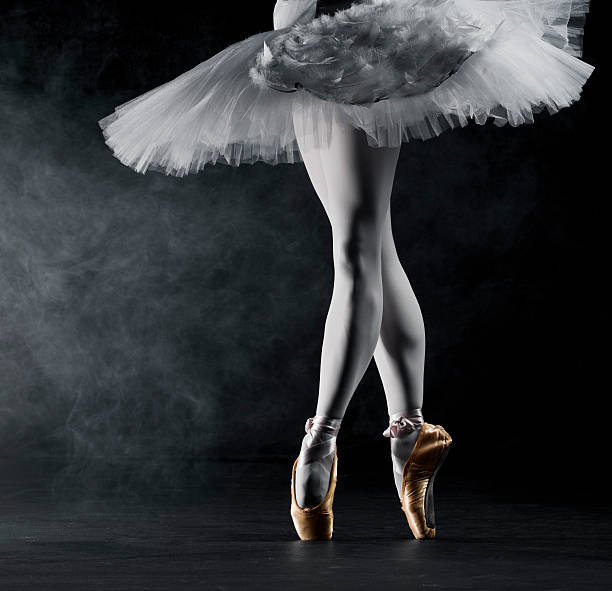 Ballerina in tip on stage Young female ballerina standing on toes, low section ballet dancer feet stock pictures, royalty-free photos & images