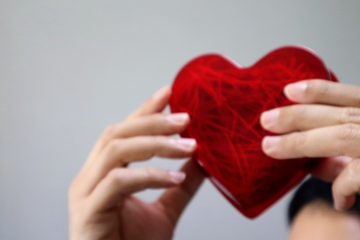 Close-up photo of a person holding a heart