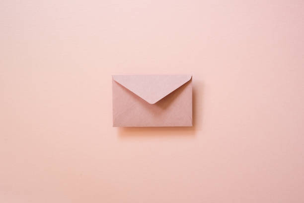 istock Envelope isolated on pink background. top view, copy space 1672655093