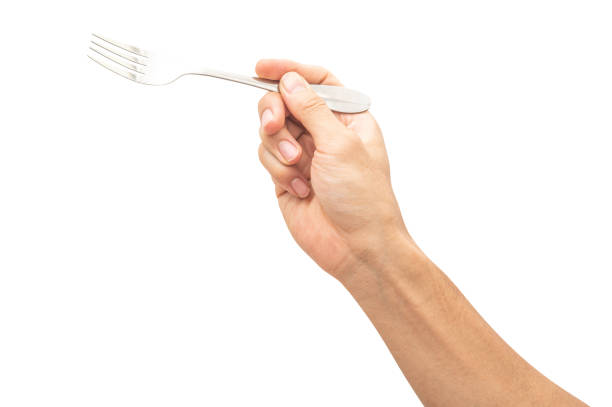 istock isolated of a man's hand holding a silver steel fork. 1672683177