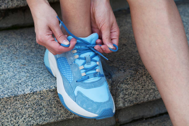 istock Sportswoman tying shoes 1672688910