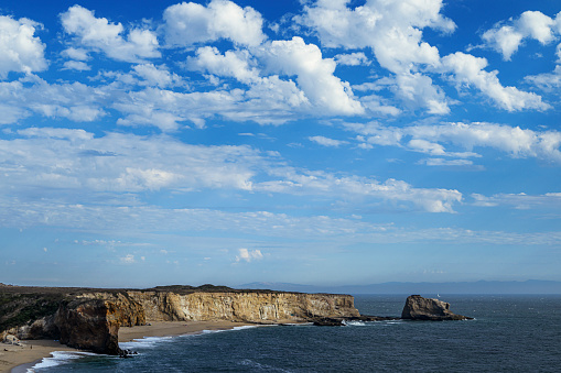 Wide coastal view of Panther and Hole in the Wall beaches under cloudy sky.\n\nTaken from Northern California, USA