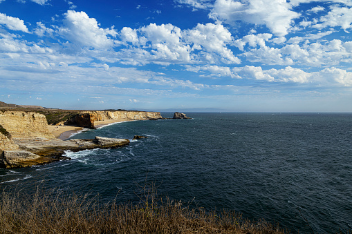 Wide coastal view of Panther and Hole in the Wall beaches under cloudy sky.\n\nTaken from Northern California, USA