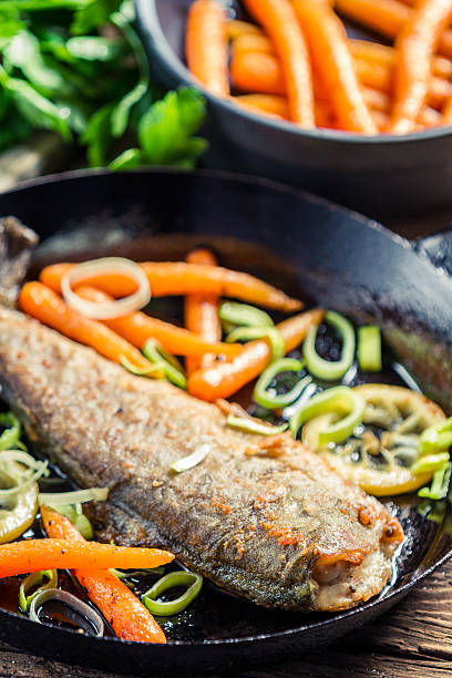 istock Closeup of fresh fish fried in a pan 167272698