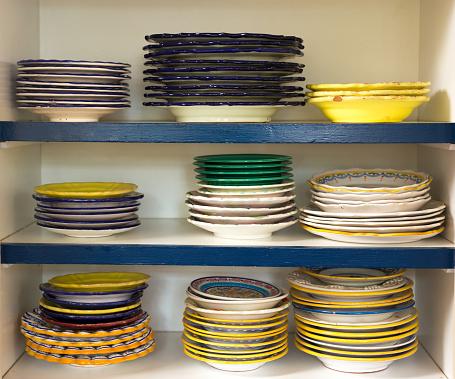 Rustic Kitchen: Shelves of Rustic Painted Dishes. Shot in Santa Fe, NM.