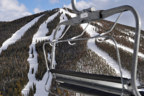 Chair lift moving past the ski slopes at Keystone, Colorado in the Rocky Mountains.