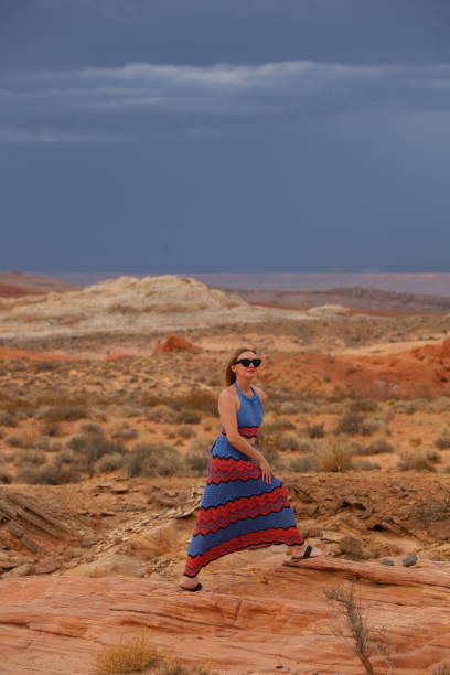 istock Young beautiful woman in desert 1672817425