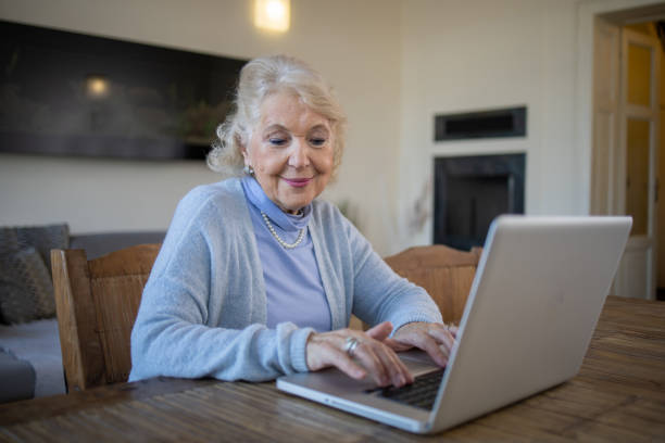 istock Elderly woman is using a laptop 1672862297