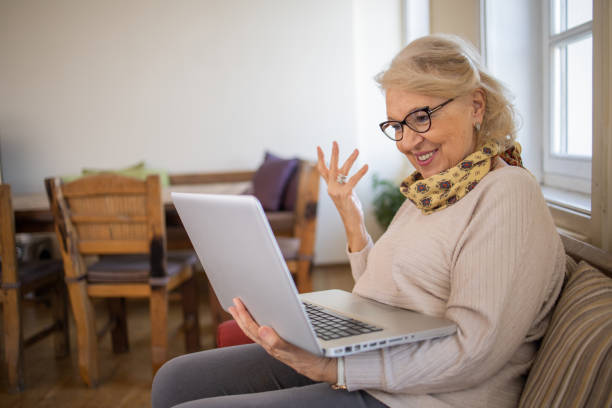 istock Elderly woman is using a laptop 1672863375