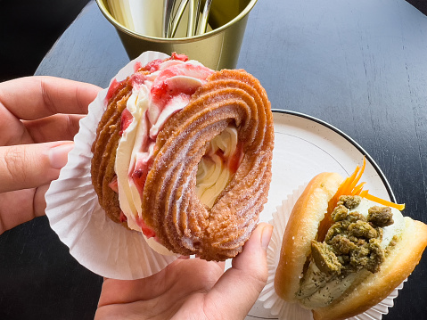 Artisanal Doughnuts - handmade strawberry French cruller and Asian matcha, cookie and candied yuzu flavors, served at an outdoor cafe in Ubud, Bali, Indonesia.