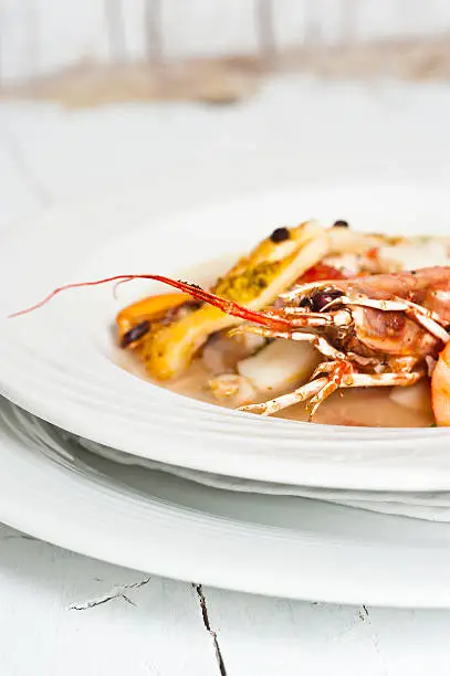 Fishsoup / bouillabaisse with mixed fish,
