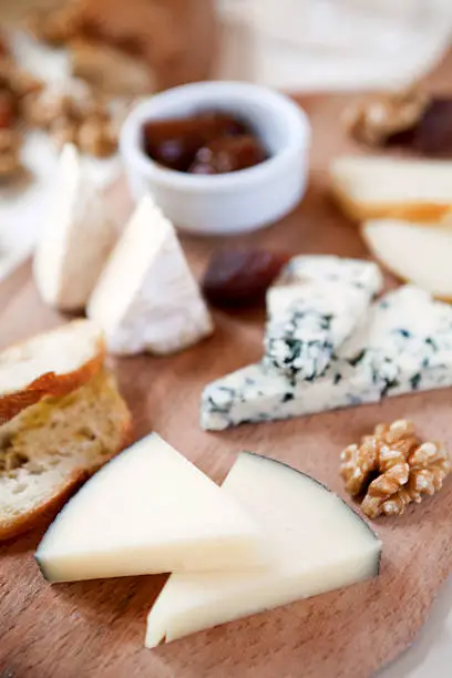A delectable cheeseboard filled with an assortment of fine imported cheeses.Shallow dof.