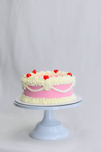 istock pink delicate cup cake with maraschino cherry for birthday celebration isolated on white 1672872606