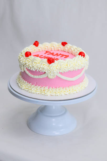 istock pink delicate cup cake with maraschino cherry for birthday celebration isolated on white 1672872609